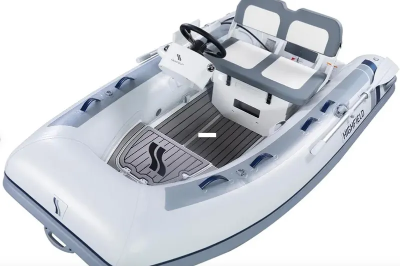 Irish Ayes Yacht Photos Pics White and gray inflatable boat with seating, steering wheel, and Highfield branding.