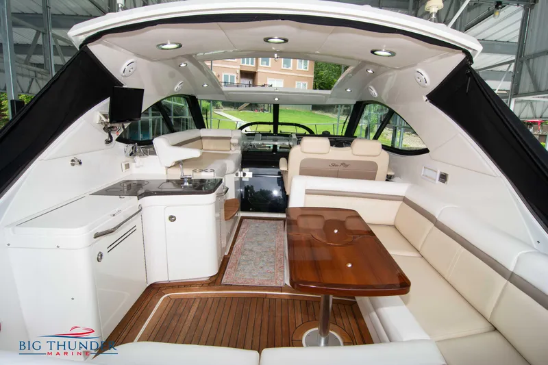  Yacht Photos Pics Luxurious interior of 2012 Sea Ray 410 Sundancer yacht with elegant seating and kitchenette.