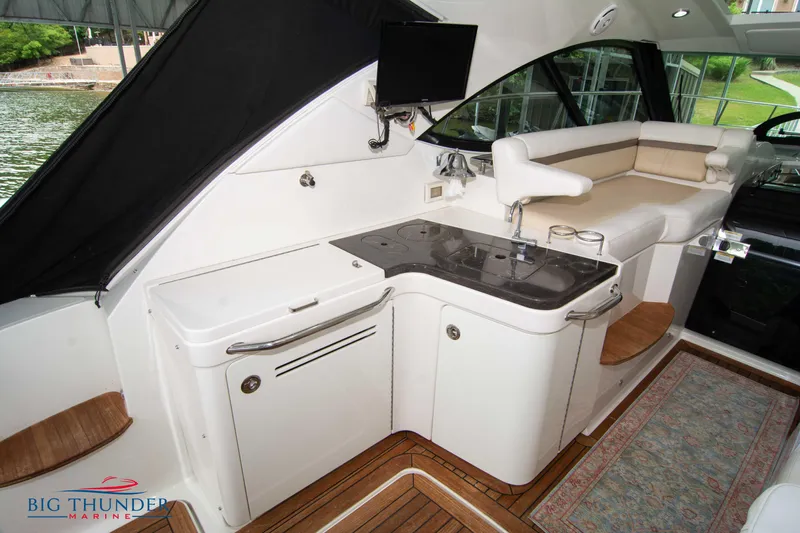 Yacht Photos Pics Luxurious interior of 2012 Sea Ray 410 Sundancer yacht with kitchenette and seating area.