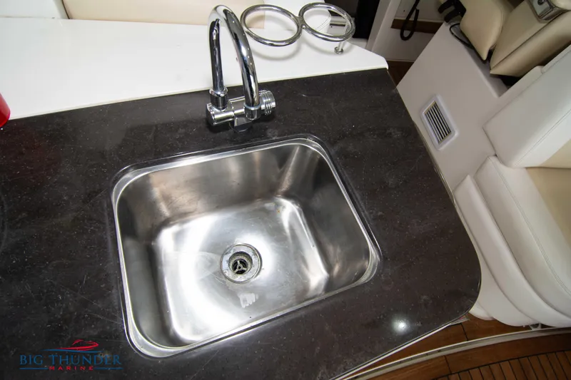  Yacht Photos Pics Stainless steel sink on 2012 Sea Ray 410 Sundancer yacht with black countertop.