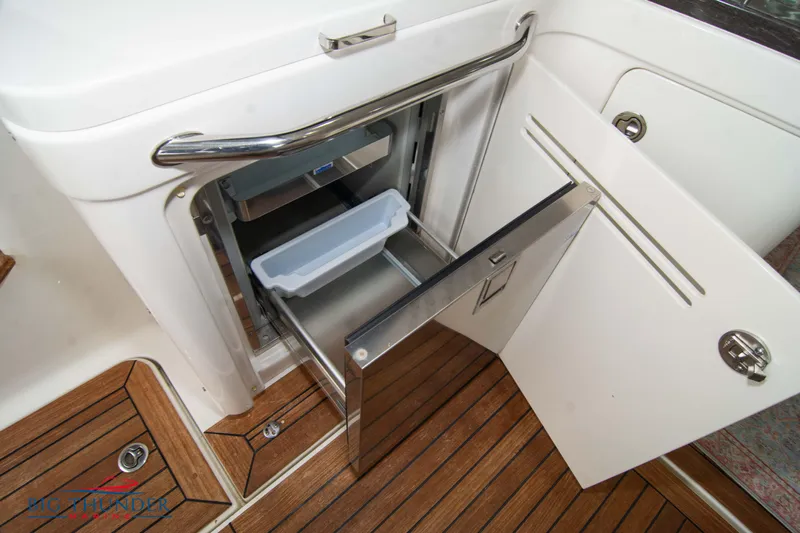  Yacht Photos Pics 2012 Sea Ray 410 Sundancer boat interior with open storage compartment and wooden flooring.