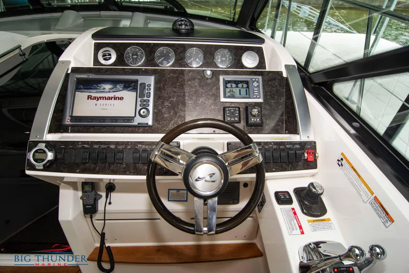  Yacht Photos Pics Control panel of 2012 Sea Ray 410 Sundancer yacht with navigation equipment and steering wheel.