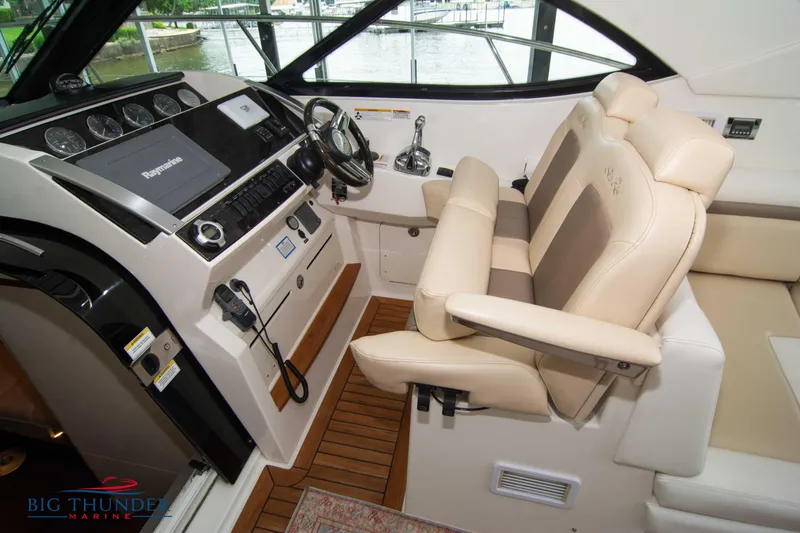  Yacht Photos Pics Luxurious 2012 Sea Ray 410 Sundancer helm with leather seating and advanced navigation controls.