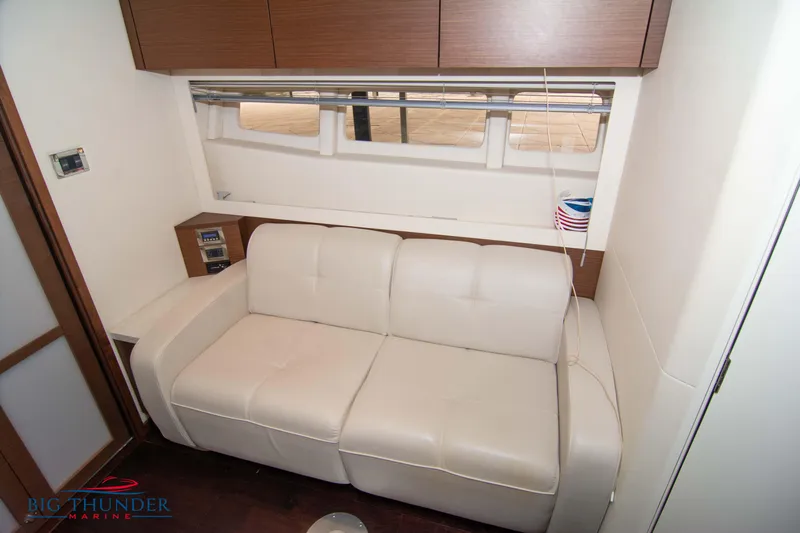  Yacht Photos Pics Interior of 2012 Sea Ray 410 Sundancer with white leather sofa and wooden cabinets.