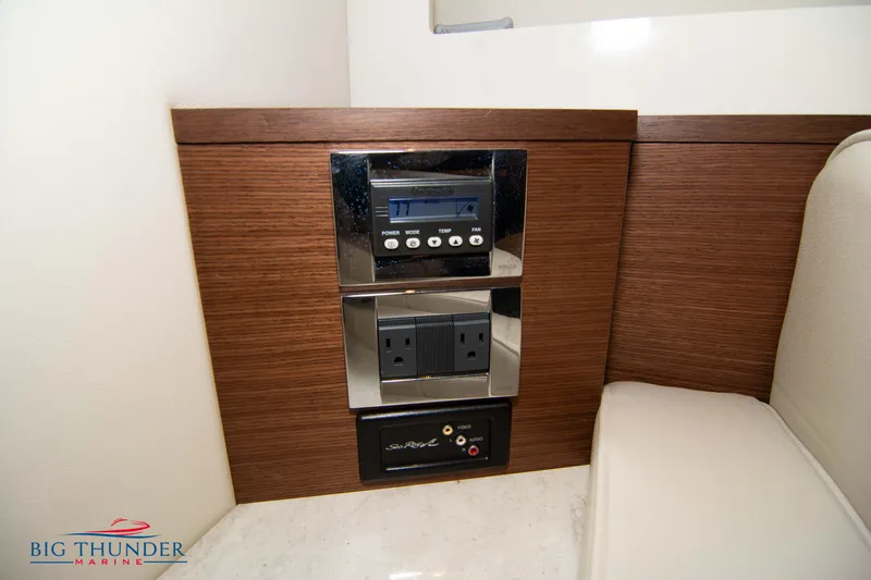  Yacht Photos Pics 2012 Sea Ray 410 Sundancer interior control panel with outlets and wood finish.