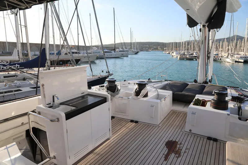  Yacht Photos Pics Luxurious Lagoon 620 yacht deck with modern amenities, docked in a serene marina.