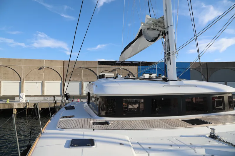  Yacht Photos Pics 2020 Lagoon 620 catamaran docked, showcasing sleek design and spacious deck.