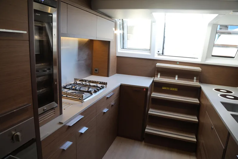  Yacht Photos Pics Modern kitchen interior of 2020 Lagoon 620 yacht with sleek cabinetry and appliances.