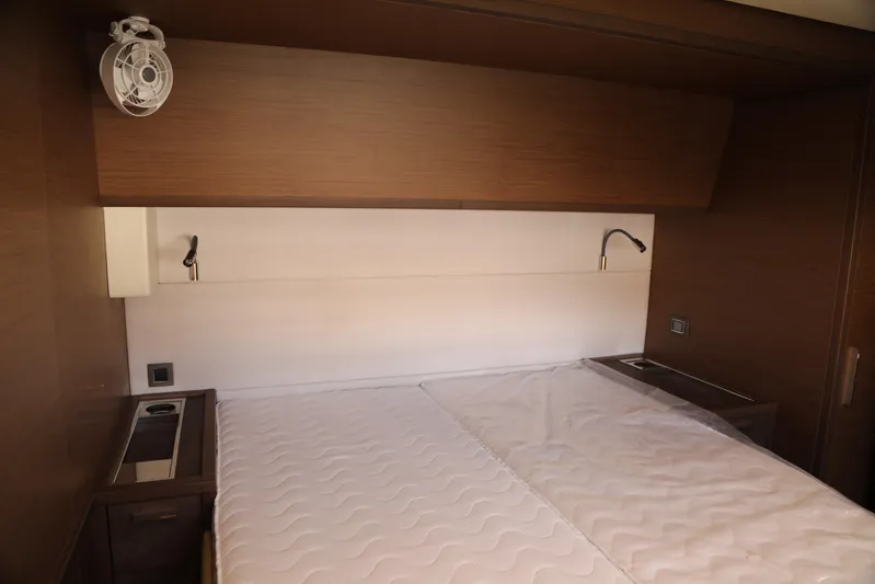  Yacht Photos Pics Luxurious cabin interior of 2020 Lagoon 620 yacht with modern wood finish.