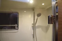 Shower area in 2020 Lagoon 620 yacht with modern fixtures and window.