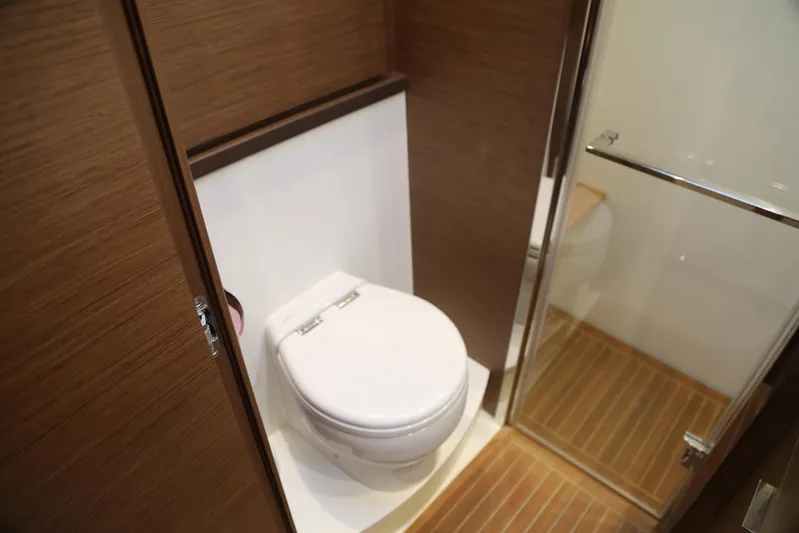  Yacht Photos Pics Bathroom interior of 2020 Lagoon 620 yacht with wooden accents and modern fixtures.