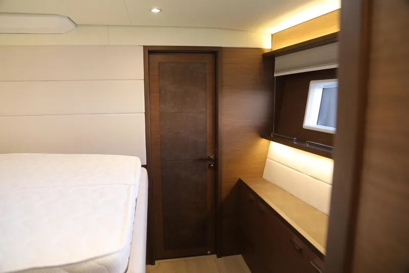  Yacht Photos Pics Luxurious interior of 2020 Lagoon 620 yacht cabin with modern wood finishes.
