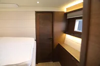 Luxurious interior of 2020 Lagoon 620 yacht cabin with modern wood finishes.