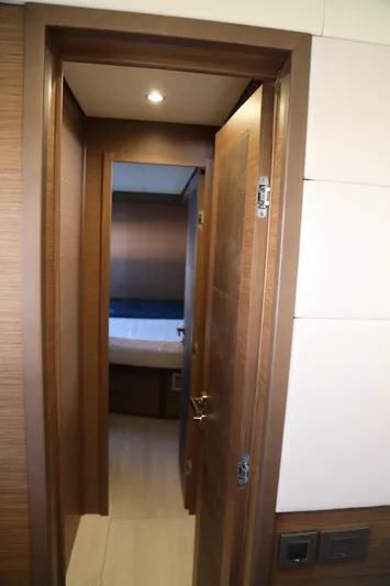  Yacht Photos Pics Interior view of Lagoon 620 yacht, featuring a wooden door and modern design elements.