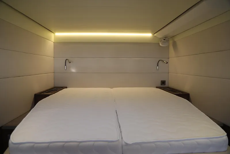  Yacht Photos Pics Luxurious cabin interior of 2020 Lagoon 620 yacht with modern lighting and twin beds.