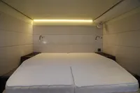Luxurious cabin interior of 2020 Lagoon 620 yacht with modern lighting and twin beds.