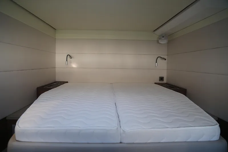  Yacht Photos Pics Interior cabin of 2020 Lagoon 620 yacht with double bed and reading lights.