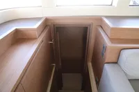 Interior of 2020 Lagoon 620 yacht, featuring wooden stairs and modern design elements.