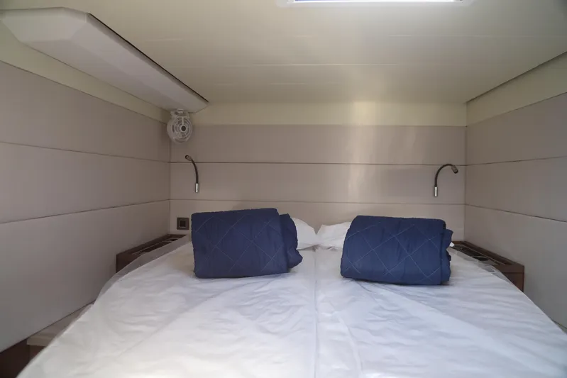  Yacht Photos Pics Luxurious cabin interior of 2020 Lagoon 620 yacht with cozy bedding and modern lighting.