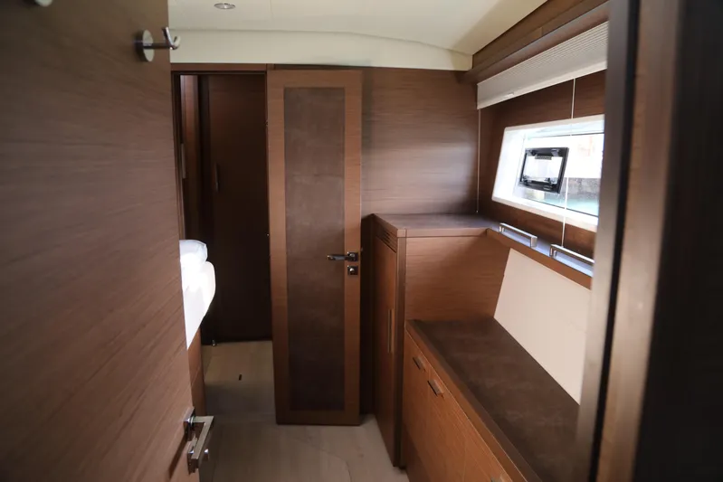  Yacht Photos Pics Interior of 2020 Lagoon 620 yacht with wooden cabinetry and window.
