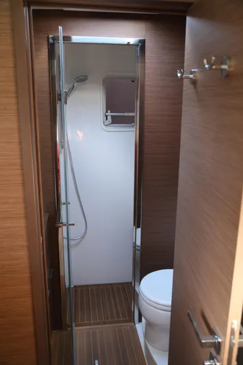  Yacht Photos Pics 2020 Lagoon 620 yacht bathroom with shower, wooden accents, and modern fixtures.