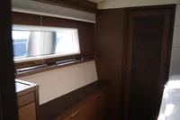 Interior of 2020 Lagoon 620 yacht with wooden cabinetry and window.