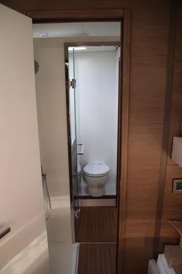  Yacht Photos Pics Lagoon 620 yacht bathroom interior, featuring modern design and wooden accents, 2020 model.