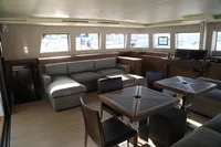 Luxurious interior of 2020 Lagoon 620 yacht with modern seating and dining area.