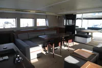Luxurious interior of 2020 Lagoon 620 yacht with modern seating and dining area.