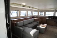 Luxurious interior of 2020 Lagoon 620 yacht with modern seating and large windows.