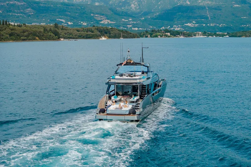 4990 Yacht Photos Pics Luxury 2024 Riva 82' Diva yacht cruising on scenic blue waters.