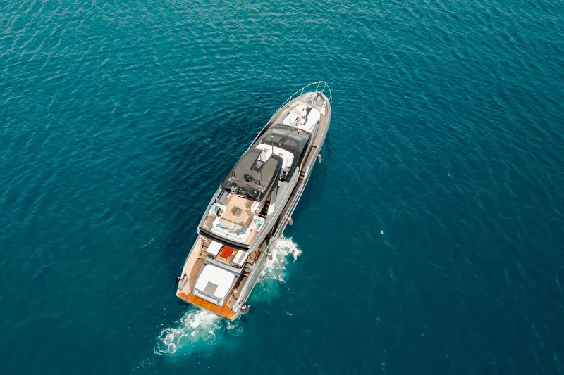 4990 Yacht Photos Pics 2024 Riva 82' Diva luxury yacht cruising on clear blue ocean waters.