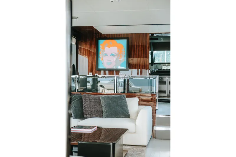 4990 Yacht Photos Pics Luxurious interior of 2024 Riva 82' Diva yacht with modern art and plush seating.