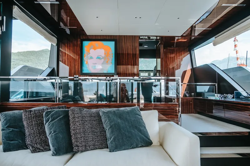 4990 Yacht Photos Pics Luxurious interior of 2024 Riva 82' Diva yacht with modern art and plush seating.