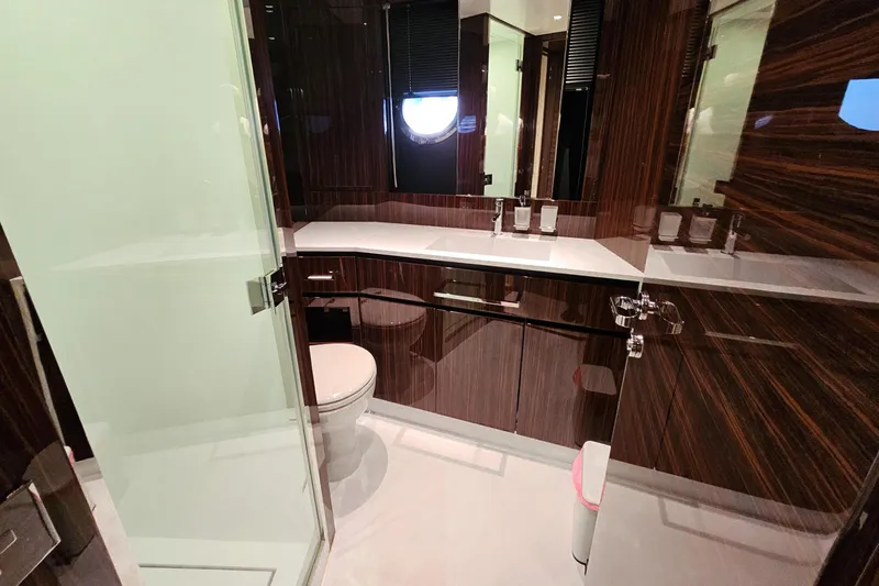 4990 Yacht Photos Pics Luxurious bathroom in 2024 Riva 82' Diva yacht with sleek wood finishes and modern fixtures.