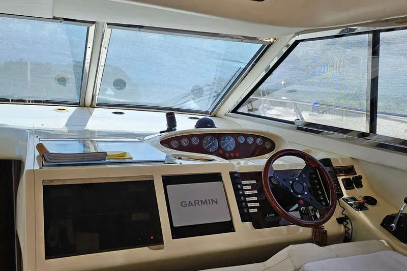 My Girls Too Yacht Photos Pics Interior view of 1998 Viking Princess 460 Sport Cruiser Flybridge helm with Garmin navigation system.