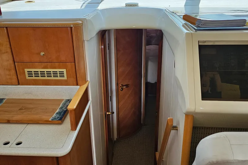 My Girls Too Yacht Photos Pics Interior of 1998 Viking Princess 460 Sport Cruiser Flybridge, featuring wood cabinetry and doorway.