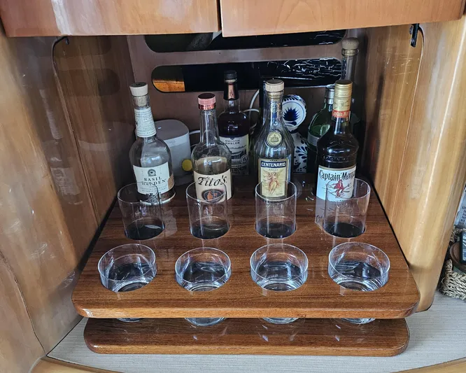 My Girls Too Yacht Photos Pics Bar setup on 1998 Viking Princess 460 Sport Cruiser Flybridge with liquor bottles and glasses.
