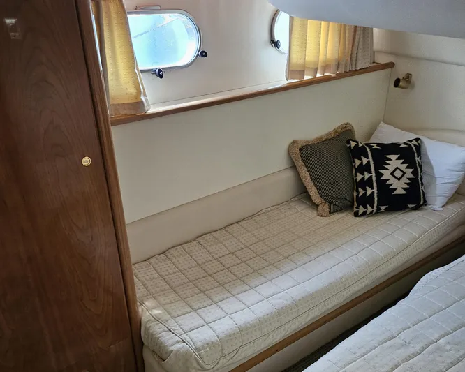 My Girls Too Yacht Photos Pics Cozy cabin interior of 1998 Viking Princess 460 Sport Cruiser with stylish cushions.