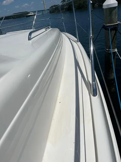 My Girls Too Yacht Photos Pics 1998 Viking Princess 460 Sport Cruiser Flybridge, sleek deck view by the water.