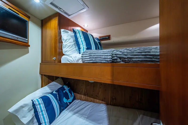  Yacht Photos Pics Cozy bunk beds in 2006 Bertram 630 Convertible yacht cabin with nautical decor.