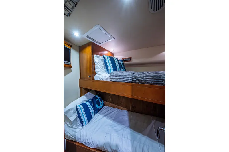  Yacht Photos Pics Bunk beds in 2006 Bertram 630 Convertible yacht cabin with nautical-themed pillows.