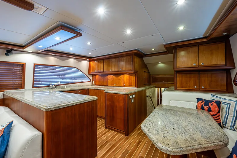  Yacht Photos Pics Luxurious interior of 2006 Bertram 630 Convertible yacht with wood cabinetry and granite countertops.