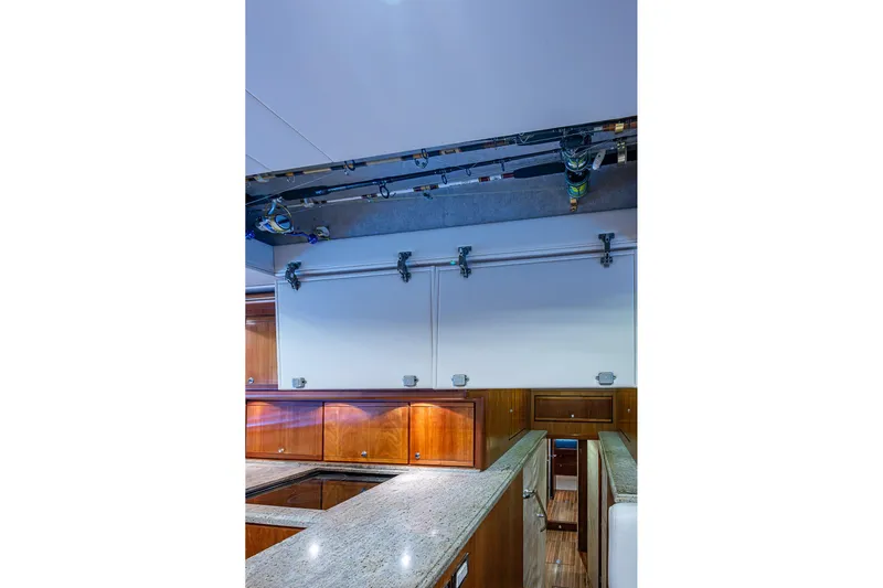  Yacht Photos Pics Interior of 2006 Bertram 630 Convertible yacht with granite countertops and wooden cabinetry.