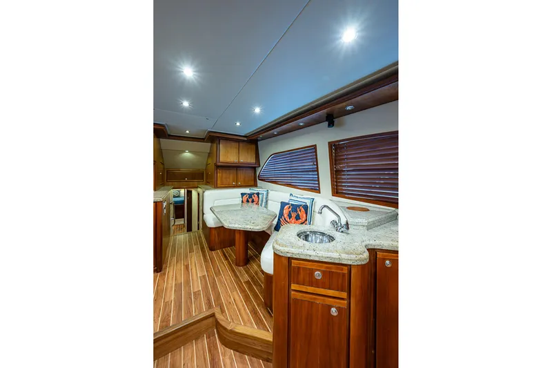  Yacht Photos Pics Luxurious interior of 2006 Bertram 630 Convertible yacht with wood finishes and modern amenities.