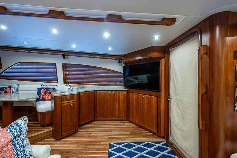  Yacht Photos Pics Luxurious interior of 2006 Bertram 630 Convertible yacht with wood finishes and modern amenities.
