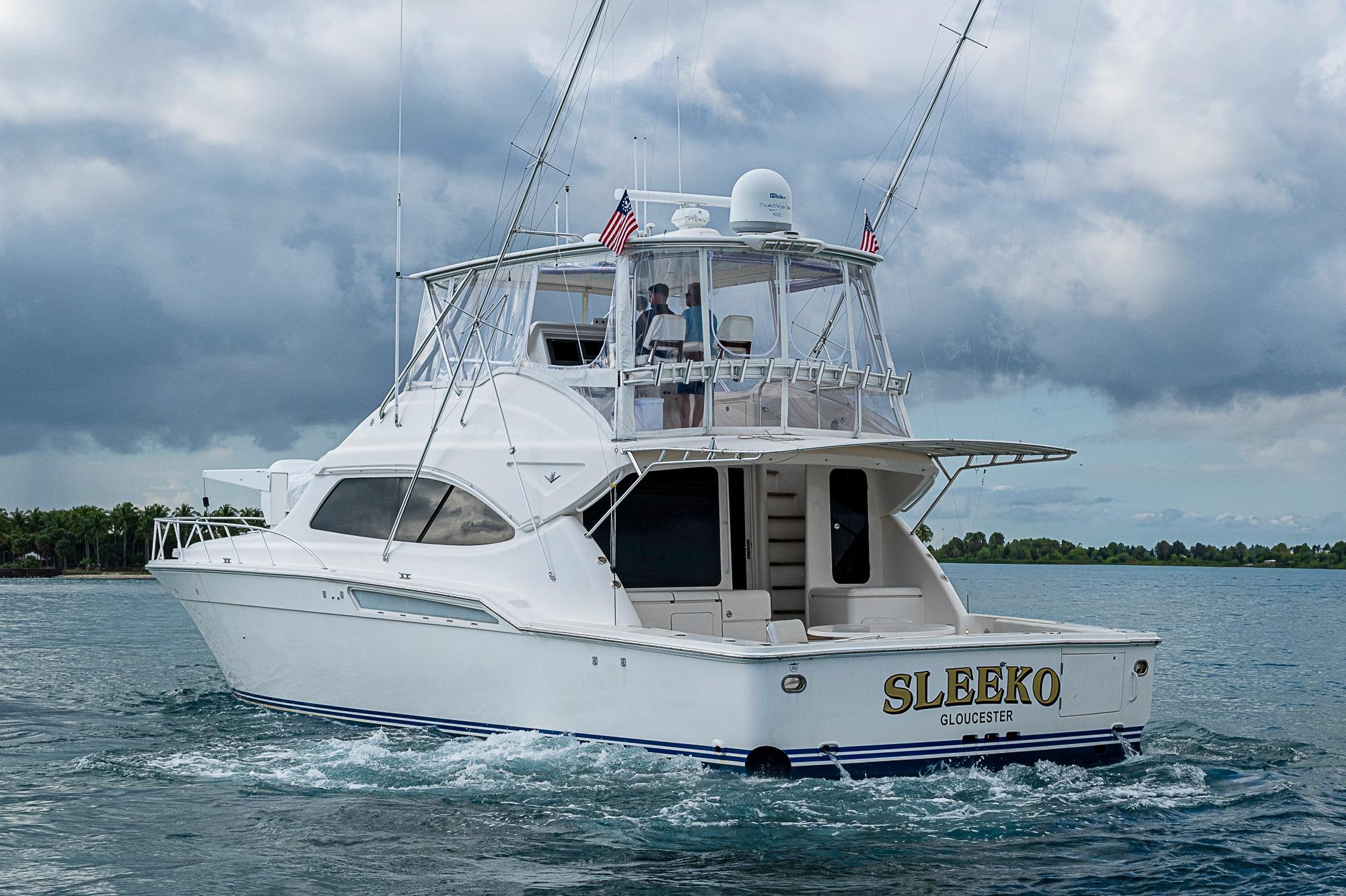 2006 Bertram 630 Convertible yacht cruising on open water under cloudy skies.