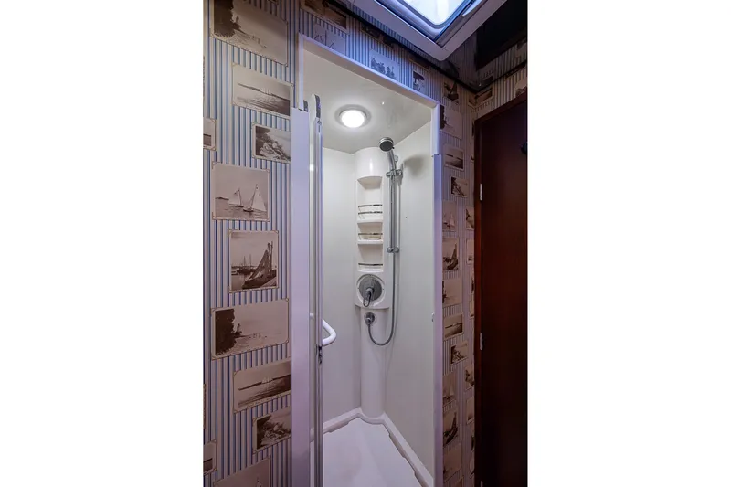  Yacht Photos Pics Shower area in 2006 Bertram 630 Convertible yacht with nautical-themed wallpaper.