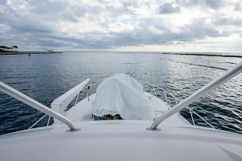  Yacht Photos Pics 2006 Bertram 630 Convertible yacht on open water under cloudy sky.