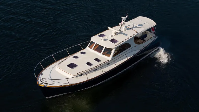 Chic Yacht Photos Pics 2003 Hinckley Talaria 44 Express yacht cruising on open water.